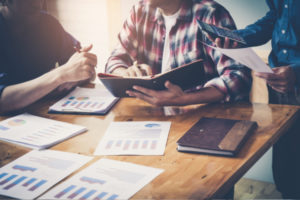 People at a table reviewing documents