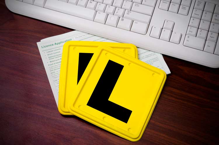 Yellow L plates near a licence applicastion and keyboard